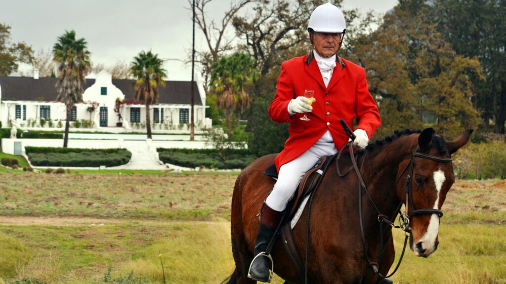 man riding horse on farm during daytime