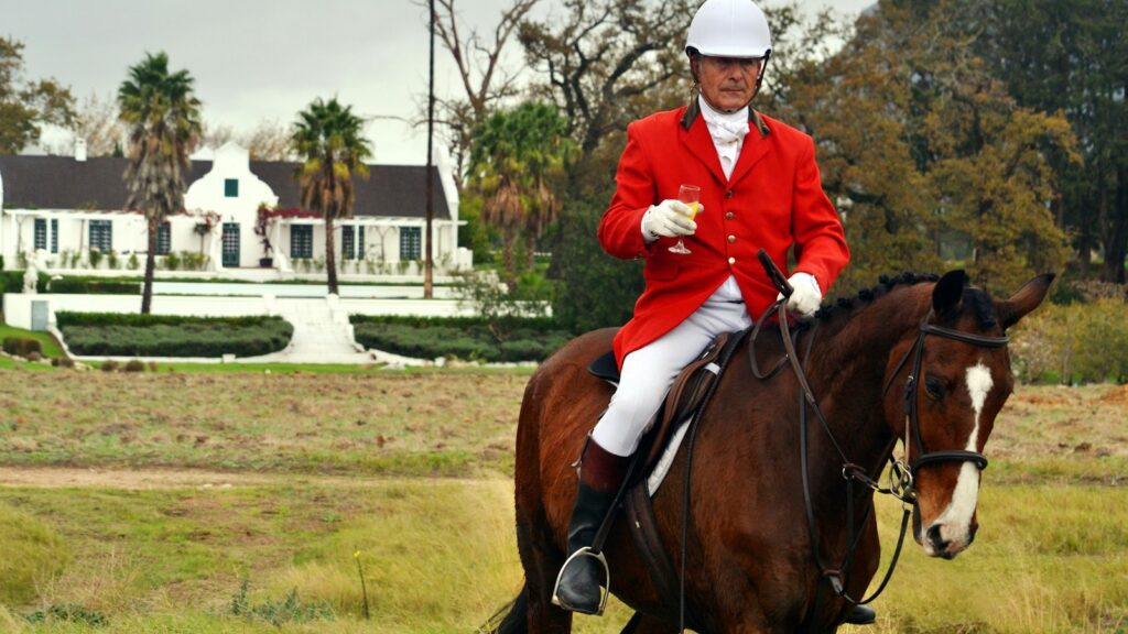 man riding horse on farm during daytime