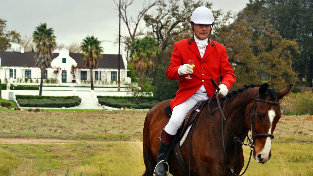 man riding horse on farm during daytime