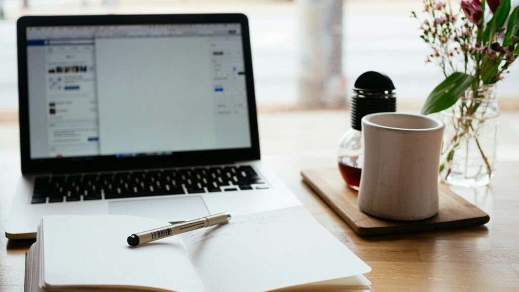 MacBook Pro near white open book