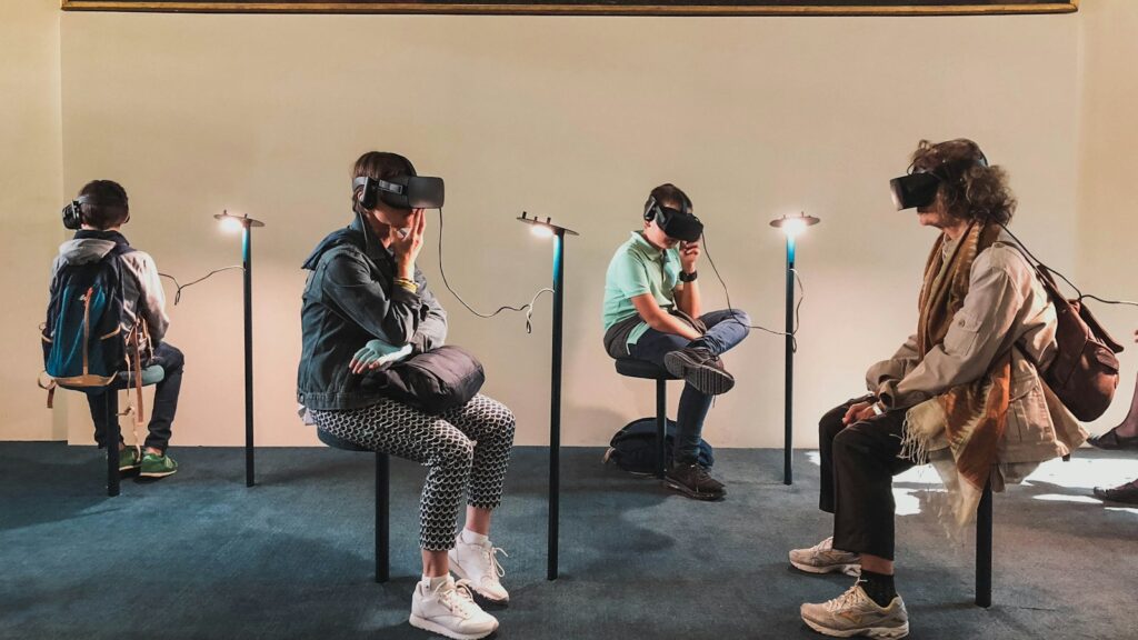 four person playing virtual reality goggles