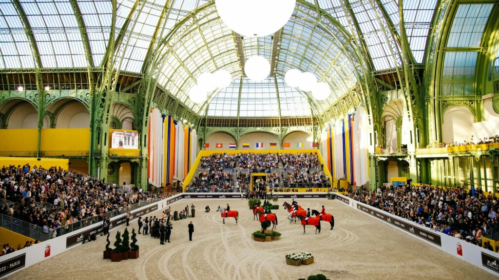 people riding horses in stadium