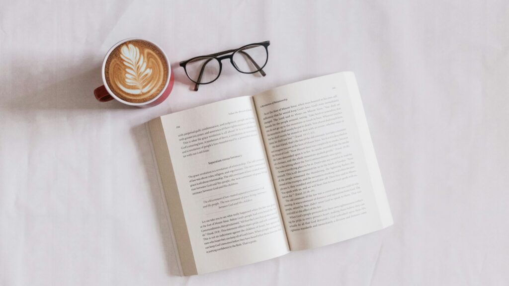 book near eyeglasses and cappuccino