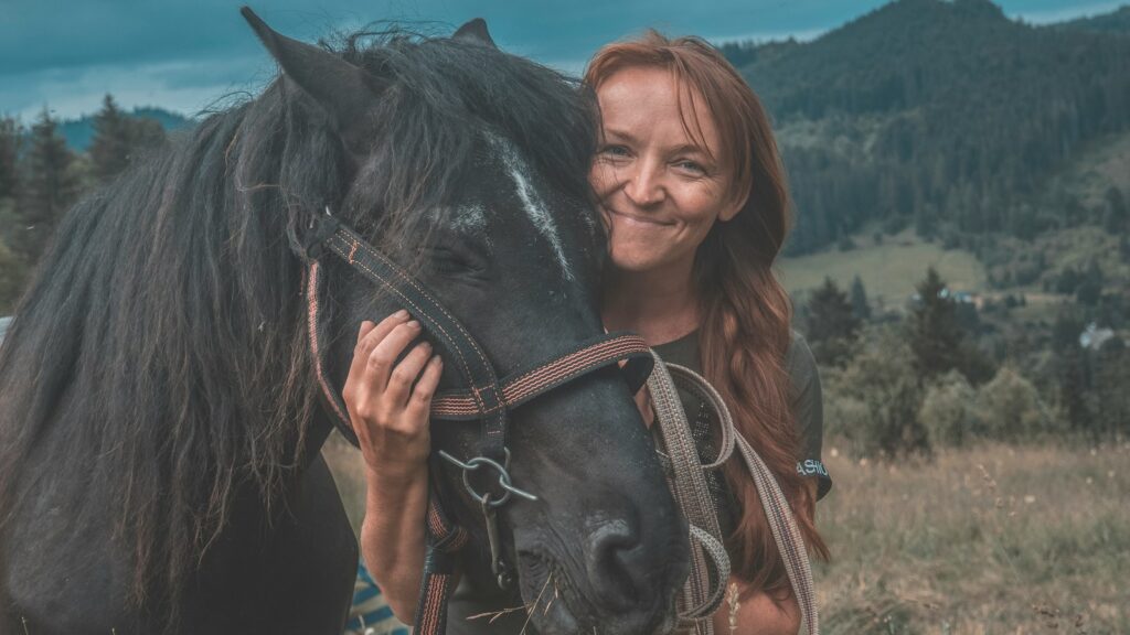 woman holding horse