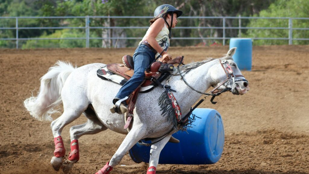 woman riding horse during daytime