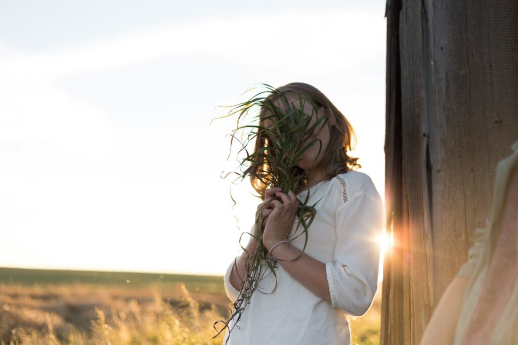 woman holding green plants